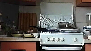 A Sexy Naked Woman Prepares Food in the Kitchen