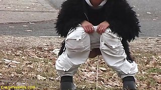 Young girl pissing on street