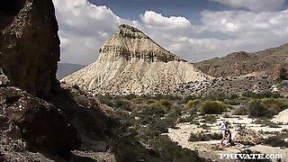 Natalia Zeta outdoor missionary beside patterned tent in rocky desert
