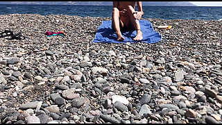 Cute exhibitionist girl get naked in public beach