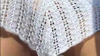 Hot crown sunbathing on the beach in transparent micro bikini