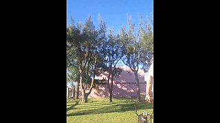 Stepmother in a Bikini in the Garden of the House Makes a Video for Her Stepson, to Show off Her New Clothes.