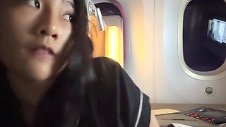 Business-class flight flashing by a petite rich Asian girl