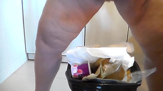 Jen is peeing into the trash can