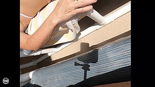 Sunning on the balcony in plain view of everyone walking by