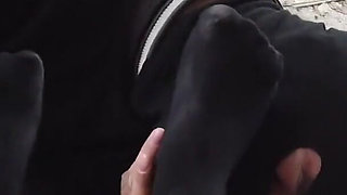 He worships her black stocking feet